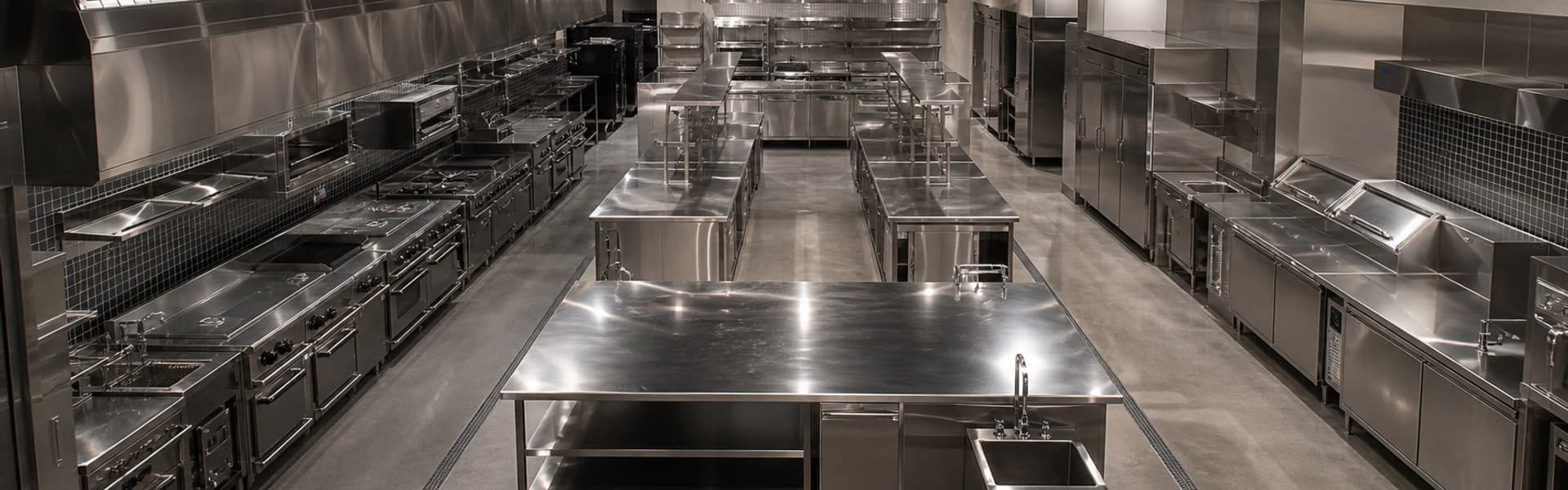 Custom commercial kitchen layout with stainless workstations